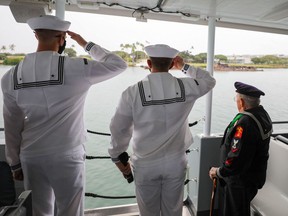 Sailors from Joint Base Pearl Harbor-Hickam and Second World War veteran Gil Nadeau render honours to the fallen service members at the USS Utah Memorial as part of the 80th Anniversary Pearl Harbor Remembrance.