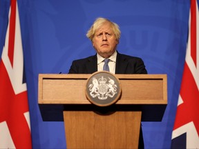 British Prime Minister Boris Johnson holds a news conference for the latest COVID-19 update in the Downing Street briefing room, in London, Dec. 8, 2021.