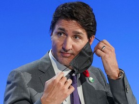 Prime Minister Justin Trudeau removes his face mask during the UN Climate Change Conference (COP26) in Glasgow, Scotland, Britain, November 2, 2021.
