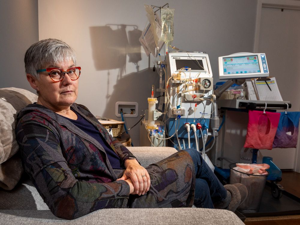 Jacqui Hunt, on Friday Dec. 10, 2021, in her home in Edmonton. Hunt has a degenerative genetic lung condition and needs a special kind of treatment that is not covered in Alberta. She is also a caregiver for her partner and helps operate the dialysis machine that is in their home.