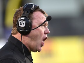 Former Canadian Football League head coach Chris Jones gets the attention of officials during a game at Commonwealth Stadium in Edmonton on Aug. 25, 2017.