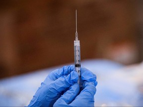 A syringe is filled with a dose of Pfizer's COVID-19 vaccine at a pop-up community vaccination center at the Gateway World Christian Center in Valley Stream, New York, U.S., Feb. 23, 2021.