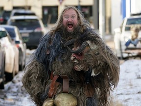 Ross Harty, dressed in a Krampus costume, navigates an icy sidewalk enroute to a photo session at a local business in Old Strathcona on Thursday December 9, 2021. In Central and Eastern Alpine folklore, the Krampus is a yuletide creature who assists Saint Nicholas and disciplines naughty children around Christmas time. Krampus will be in attendance at the Edmonton Christmas Market at Fort Edmonton Park on Sunday December 12, 2021. (PHOTO BY LARRY WONG/POSTMEDIA)