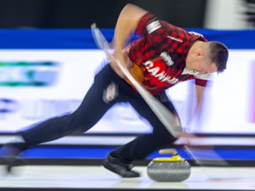 Ben Hebert sweeps his own rock during the mixed doubles competition at the Continental Cup at the Western Fair Sports Centre in London, Ont., on Jan. 11, 2020.