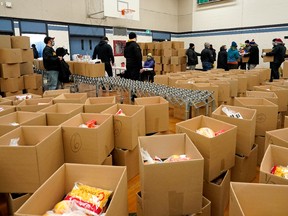 Hundreds of volunteers helped fill and deliver Christmas hampers to 1,200 Edmonton households on Saturday, Dec. 18, 2021 at St. Francis of Assisi School in Edmonton. The Christmas Bureau has been providing food hampers to Edmontonians in need for 81 years. Over 35,000 people will need help this year.