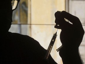 A health worker prepares a dose of the Covishield AstraZeneca-Oxford’s COVID-19 coronavirus vaccine at a vaccination centre in Karachi on May 20, 2021.