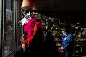 I love photos of weird, surreal little moments. Here Claudette Kirkwood works on a new window display at the Rocket Fizz candy store on Jan. 20, 2021.