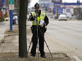 An Edmonton Police Service constable  tracks motorists speeding on 104 Street at 70 Avenue in Edmonton on Wednesday April 22, 2020.