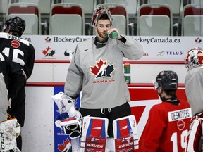 Goalie Sebastian Cossa pauses for a water break during a practice at the Canadian World Junior Hockey Championships selection camp in Calgary, Thursday, Dec. 9, 2021.THE CANADIAN PRESS/Jeff McIntosh ORG XMIT: JMC108_2021121000