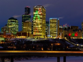 The downtown city lights glow as commuters make their way across the James MacDonald Bridge on Monday, Dec. 20, 2021 in Edmonton. Greg Southam-Postmedia