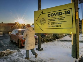 A woman walks to the parking lot at the COVID-19 testing centre at the Jewish General Hospital in Montreal on Friday January 14, 2022.