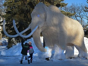 Siblings James, 3 and Georgia, 4, Miner check out the woolly mammoth on display at the 15th annual Deep Freeze: A Byzantine Winter Fête before the gates opened at 4pm which runs till January 23rd at Borden Park.