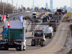 A convoy of trucks, cars and pickup trucks heads east on Highway 16A from Devon to convoy to the Alberta legislature in support of the national Freedom Convoy 2022, on Saturday, Jan. 29, 2022.