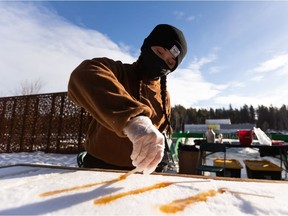 Michaylla Brissette pours tire d’érable during the All-Canadian Winter! event at the University of Alberta Botanic Garden in Parkland County west of Edmonton, on Saturday, Jan. 29, 2022. All-Canadian Winter! runs weekends from Jan. 29 through Mar. 13, 2022 from 11 a.m. – 5 p.m.