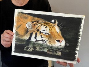 Edmonton graphic artist Wei Yew with the tiger painting he did that is now selling in a limited edition with funds going to help save the species.