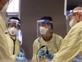 A Calgary ICU team checks a screen to help intubate a patient.