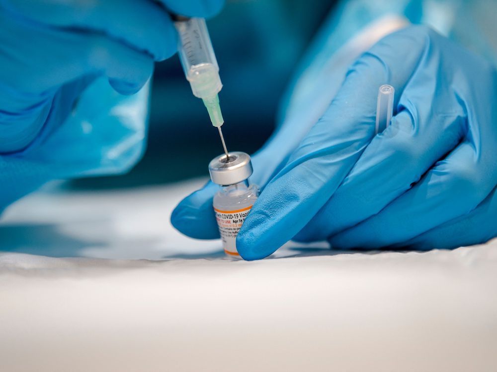  A nurse prepares the Pfizer-BioNTech Covid-19 vaccine in Montreal, Quebec on November 24, 2021. Pfizer Inc and BioNTech SE announced on Tuesday that they have a plan to study the safety and tolerability of a new shot that targets the Omicron variant.