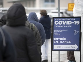 People wait in line at a COVID-19 vaccination clinic on Parc Ave. in Montreal on Wednesday December 29, 2021. While there's understandable frustration with individuals who refuse to be vaccinated because they have embraced falsehoods, forcing vaccination on them would be wrong, Brian Bird says.