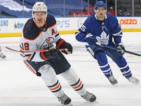 Zach Hyman (No. 18) of the Edmonton Oilers skates against the Toronto Maple Leafs during an NHL game at Scotiabank Arena in Toronto on January 5, 2022.