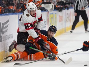 Brendan Perlini #42 of the Edmonton Oilers battles against Drake Batherson #19 of the Ottawa Senators during the first period at Rogers Place on January 15, 2022.