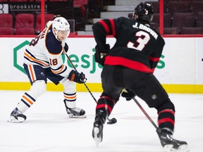 Zach Hyman (18) of the Edmonton Oilers skates against Josh Brown (3) of the Ottawa Senators at Canadian Tire Centre on Jan. 31, 2022, in Ottawa.