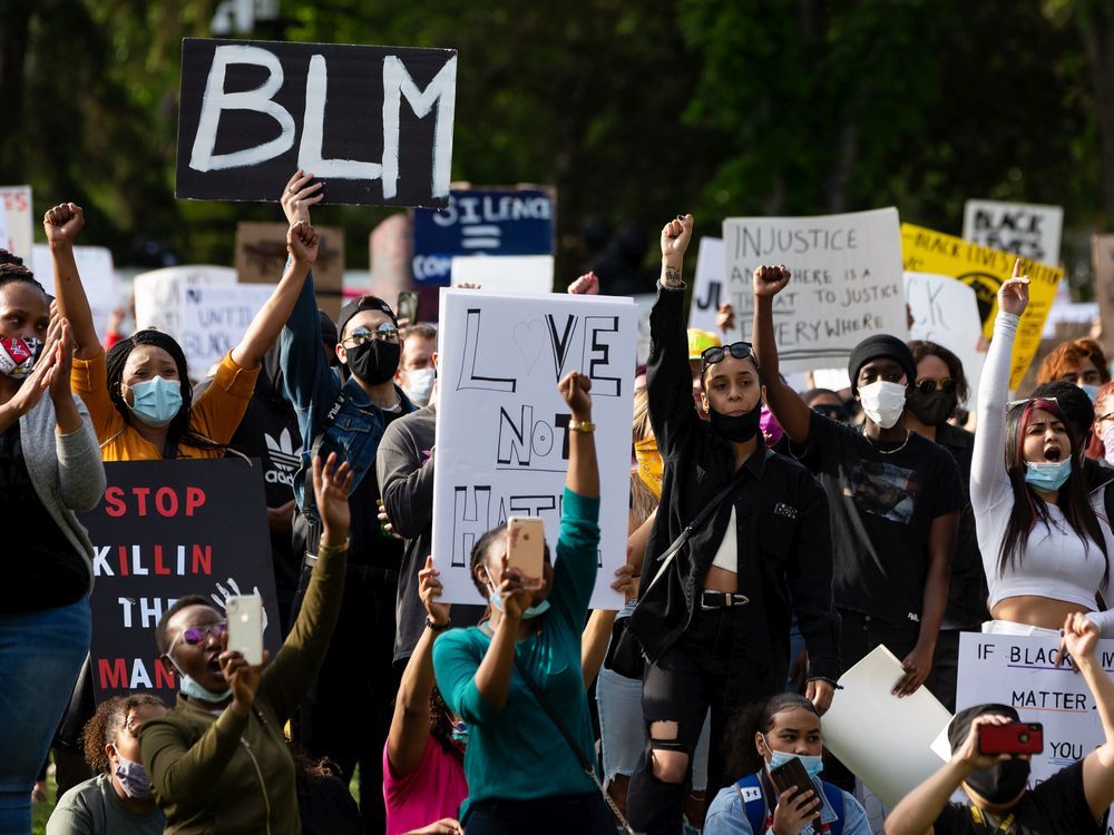 Demonstrators cheer during the A Fight for Equity rally at the Alberta Legislature in Edmonton, on Friday, June 5, 2020. 