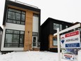 A for sale sign is seen in front of a home in the Westmount neighbourhood of Edmonton, on Friday, Feb. 12, 2021. The City of Edmonton is mailing out property assessments, the first during the COVID-19 pandemic. Photo by Ian Kucerak