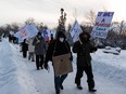 Concordia University Faculty Association members walk from the Magrath Mansion to the university during a strike  in Edmonton on Jan. 4, 2022.