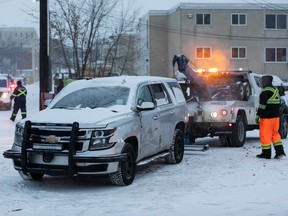 An Edmonton Police Service SUV is towed by a City of Edmonton tow truck after a collision with a pickup truck at 107 Avenue and 109 Street in Edmonton, on Friday, Jan. 7, 2022. Photo by Ian Kucerak