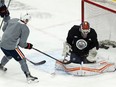 Edmonton Oilers goaltender Mikko Koskinen (19) makes a save on Derek Ryan (10) during practice at Rogers Place in Edmonton on Monday, Jan. 24, 2022.