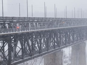 The High Level Bridge seems to disappear into the swirling snow during a snowstorm in Edmonton, on Wednesday, Dec. 22, 2021.