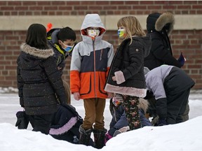 Children in the schoolyard outside Garneau School in Edmonton on Thursday, January 20, 2022.