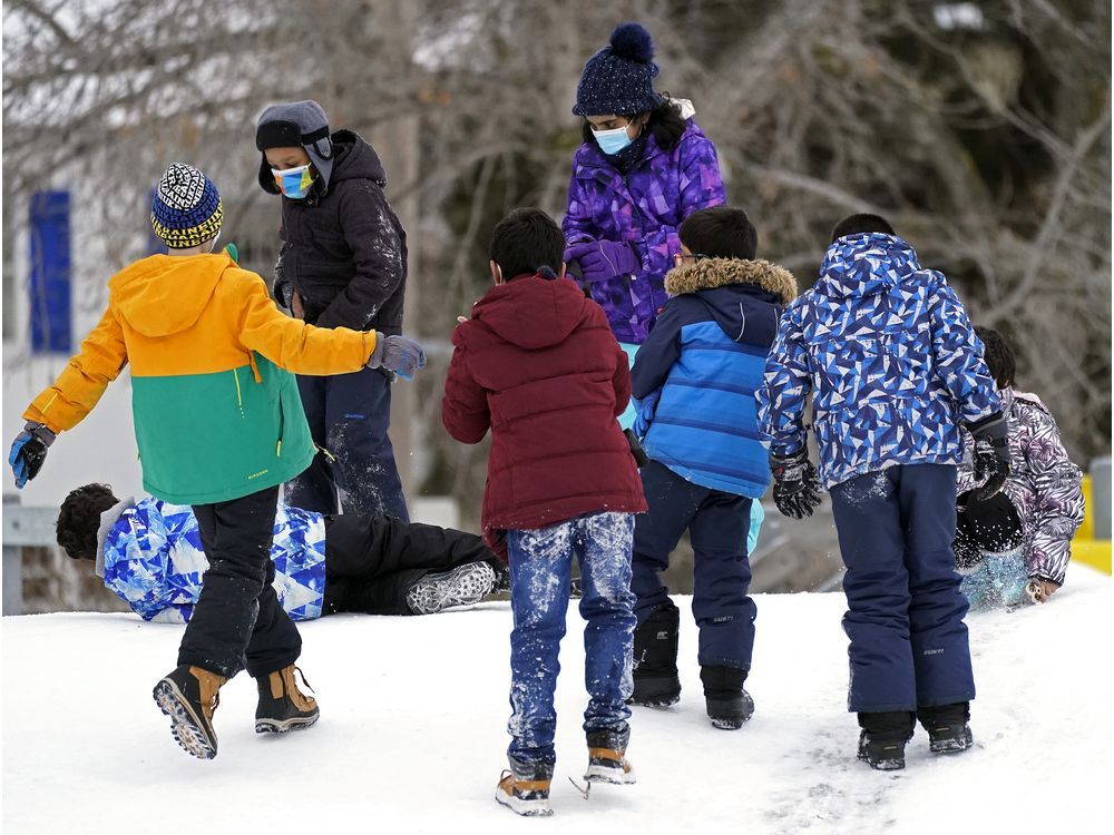 Children play in the school yard outside Garneau School in Edmonton on Thursday January 20, 2022.