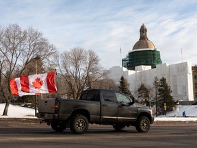 Anti-vaccination mandate convoy supporters drive past the Alberta legislature while showing support for the national Freedom Convoy 2022 in Edmonton, on Sunday, Jan. 30, 2022.