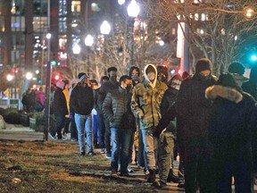 People line up to get tested for Covid-19 outside at a firehouse in Washington, DC on December 20, 2021.