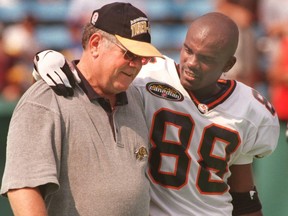 B.C. Lions wide receiver Larry Thompson chats with Hamilton Tiger-Cats head coach Don Sutherin at Ivor Wynne Stadium in Hamilton in this file photo taken on Aug. 2, 1997.