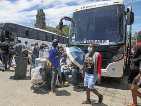 Passengers in Johannesburg, South Africa board buses traveling to Zimbabwe, amid the spread of the SARS-CoV-2 Omicron variant , December 14, 2021.