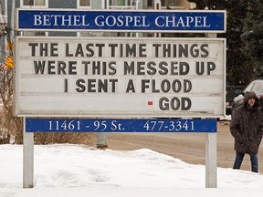 A pedestrian walks past a sign outside Bethel Gospel Chapel, 11461 95 St., in Edmonton on Friday, Jan. 21, 2022.