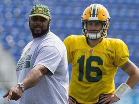 Offensive co-ordinator Stephen McAdoo (left) speaks to Edmonton Elks players beside Matt Nichols in this file photo taken at Clarke Field in Edmonton on July 21, 2015.