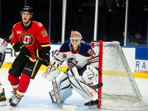 Stockton Heat centre Adam Ruzicka stands in front of the Bakersfield Condors goalie Olivier Rodrigue in an AHL game earlier this season.