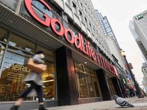 A woman walks by a closed GoodLife Fitness centre in Toronto on Jan. 5.