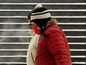 Pedestrians make their way through the extreme cold in downtown Edmonton on Wednesday, Jan. 5, 2022.