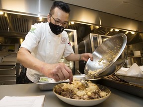 Chef Sonny Sung demonstrates how to prepare duck with glutinous rice in preparation for Lunar New Year at Evario Kitchen and Grill.