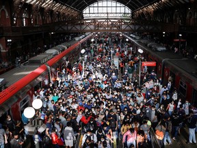 People walk after disembarking from a train in Sao Paulo, Brazil.