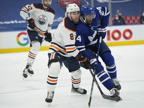 Edmonton Oilers forward Kyle Turris (8) and Toronto Maple Leafs forward Wayne Simmonds (24) battle for position during the first period at Scotiabank Arena on Jan. 5, 2021.