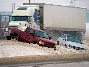 Freezing rain and snow created havoc on Edmonton area city streets and highways on Thursday Jan. 13, 2022. Multiple vehicles ended up in the ditch, like these two on Sherwood Park Freeway east of 50 Street.