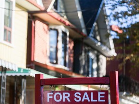 A for sale sign is displayed in front of a house in the Riverdale area of Toronto.