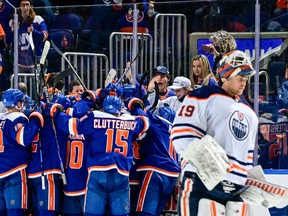 The New York Islanders celebrate their 3-2 overtime victory on a goal by Noah Dobson as Mikko Koskinen of the Edmonton Oilers reacts at UBS Arena on Jan. 1, 2022 in Elmont, New York.