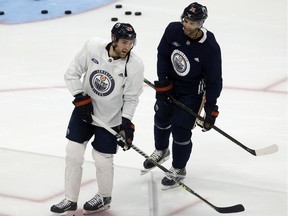 Leon Draisaitl (29) and Darnell Nurse (25) take part in an Edmonton Oilers practice at Rogers Place in Edmonton on Wednesday, Jan. 19, 2022.