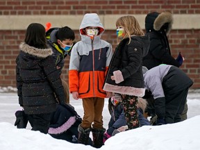 Children in the school yard outside Garneau School in Edmonton on Thursday January 20, 2022.